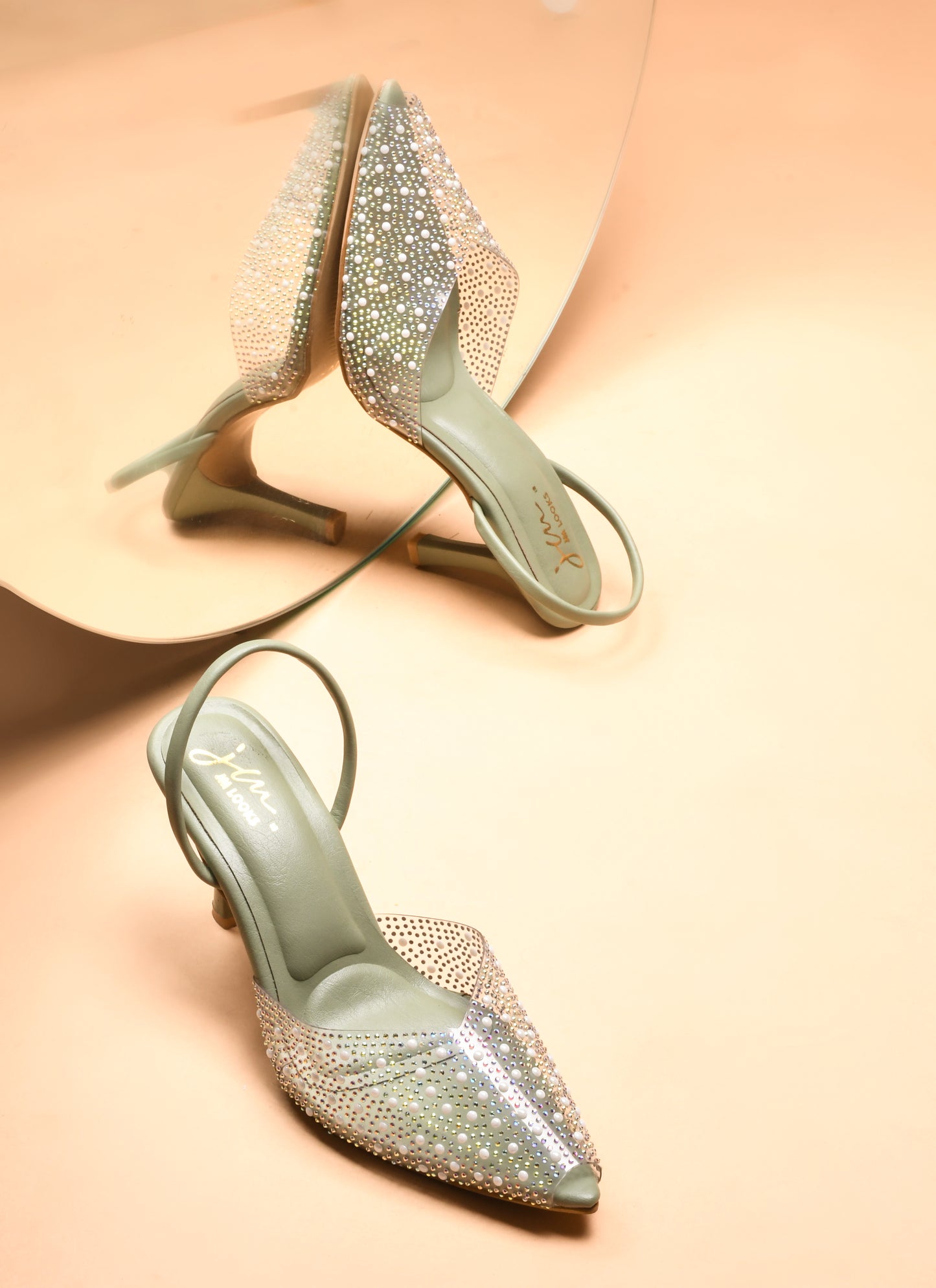 pointed toe slingback heels adorned with sparkling embellishments
Green