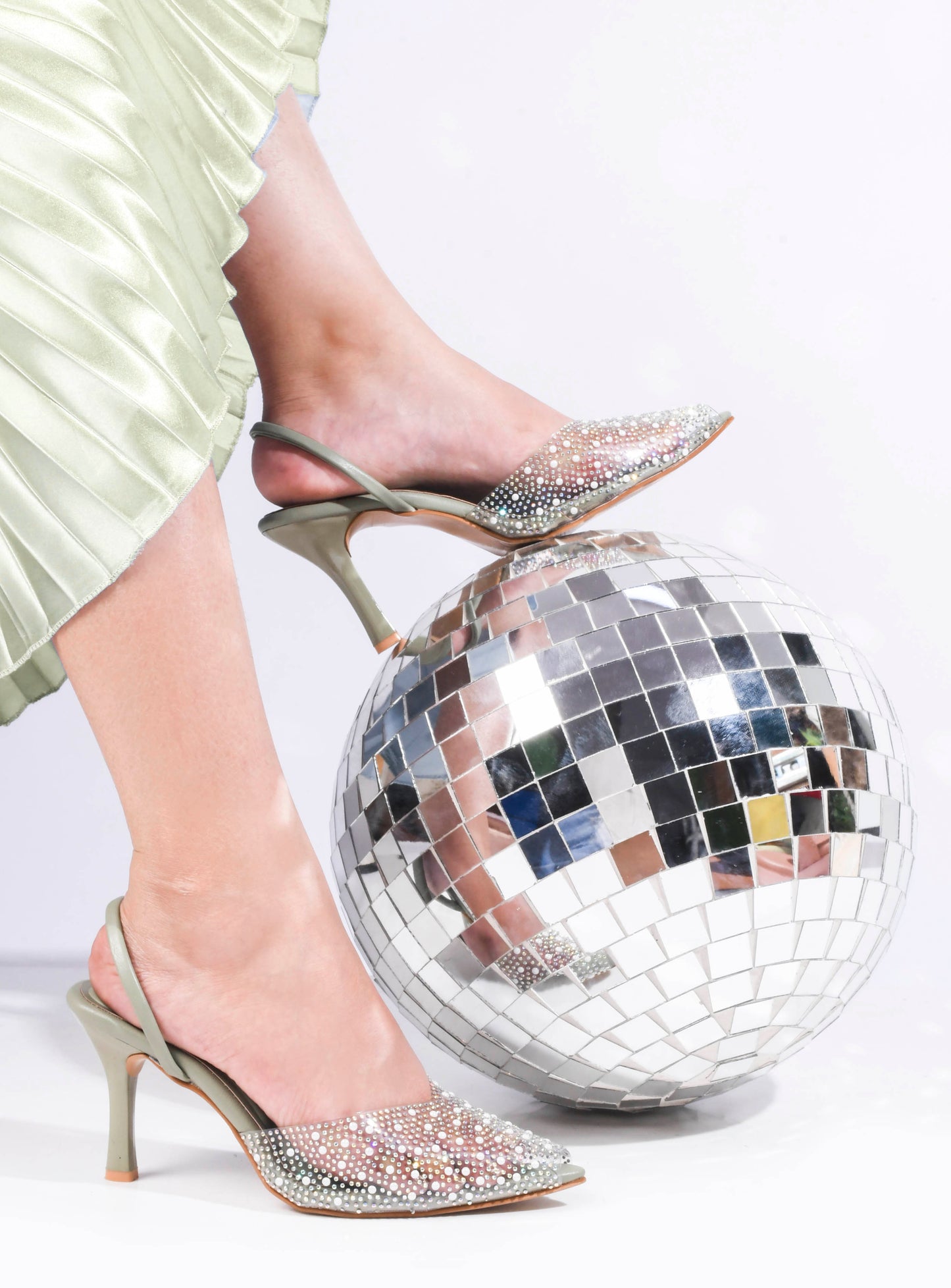 pointed toe slingback heels adorned with sparkling embellishments
Green