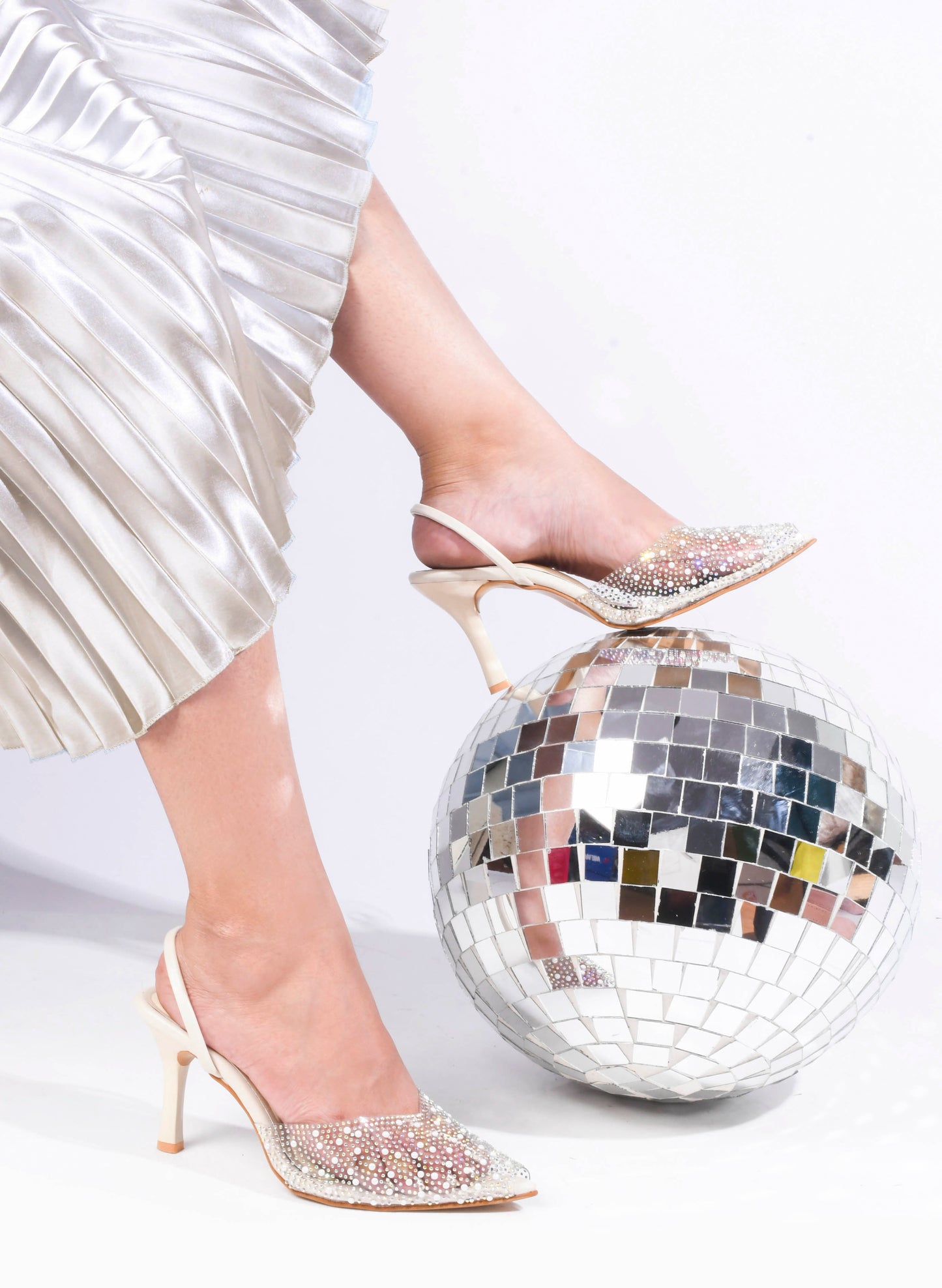 pointed toe slingback heels adorned with sparkling embellishments
Cream
