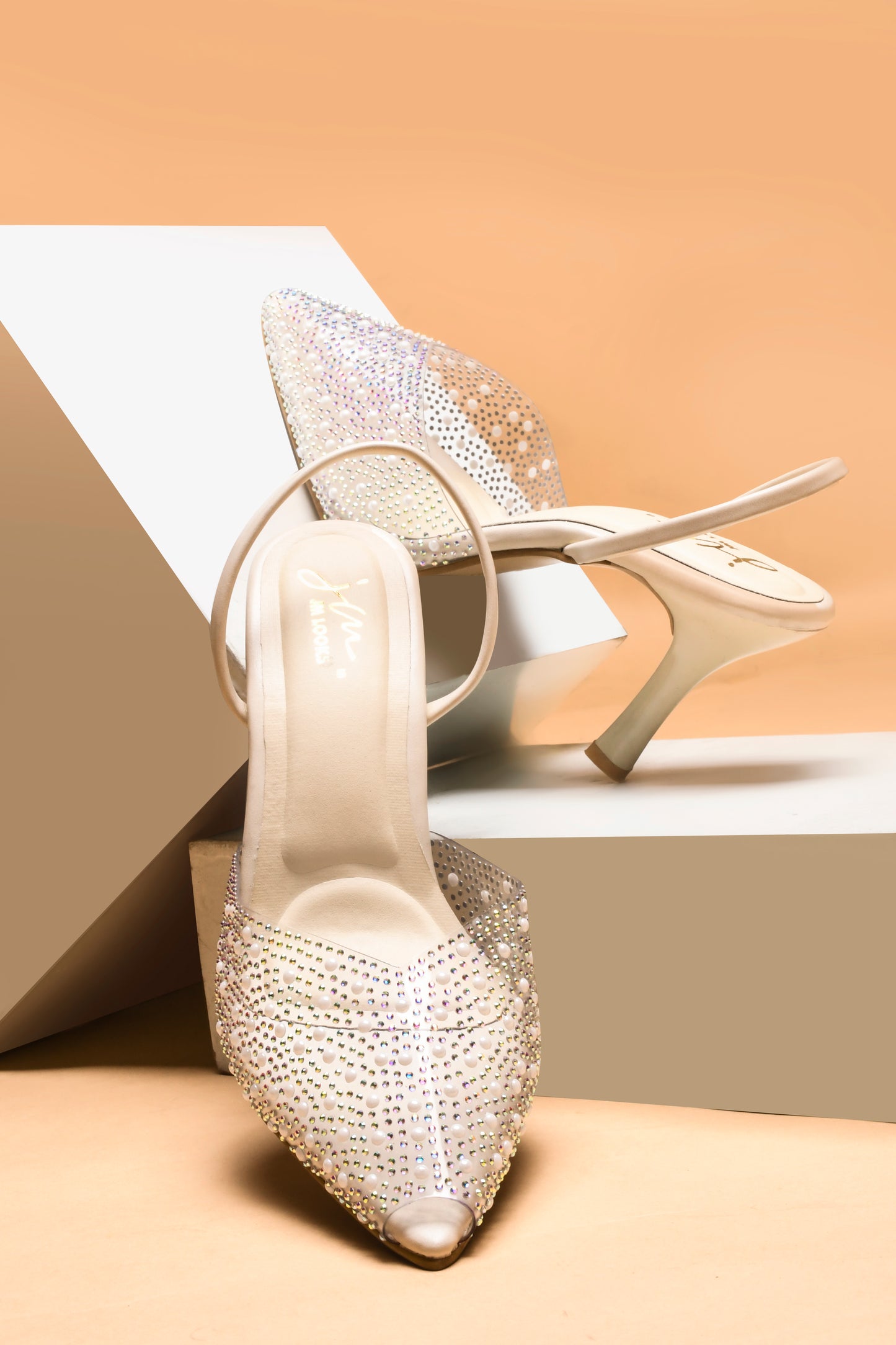 pointed toe slingback heels adorned with sparkling embellishments
Cream