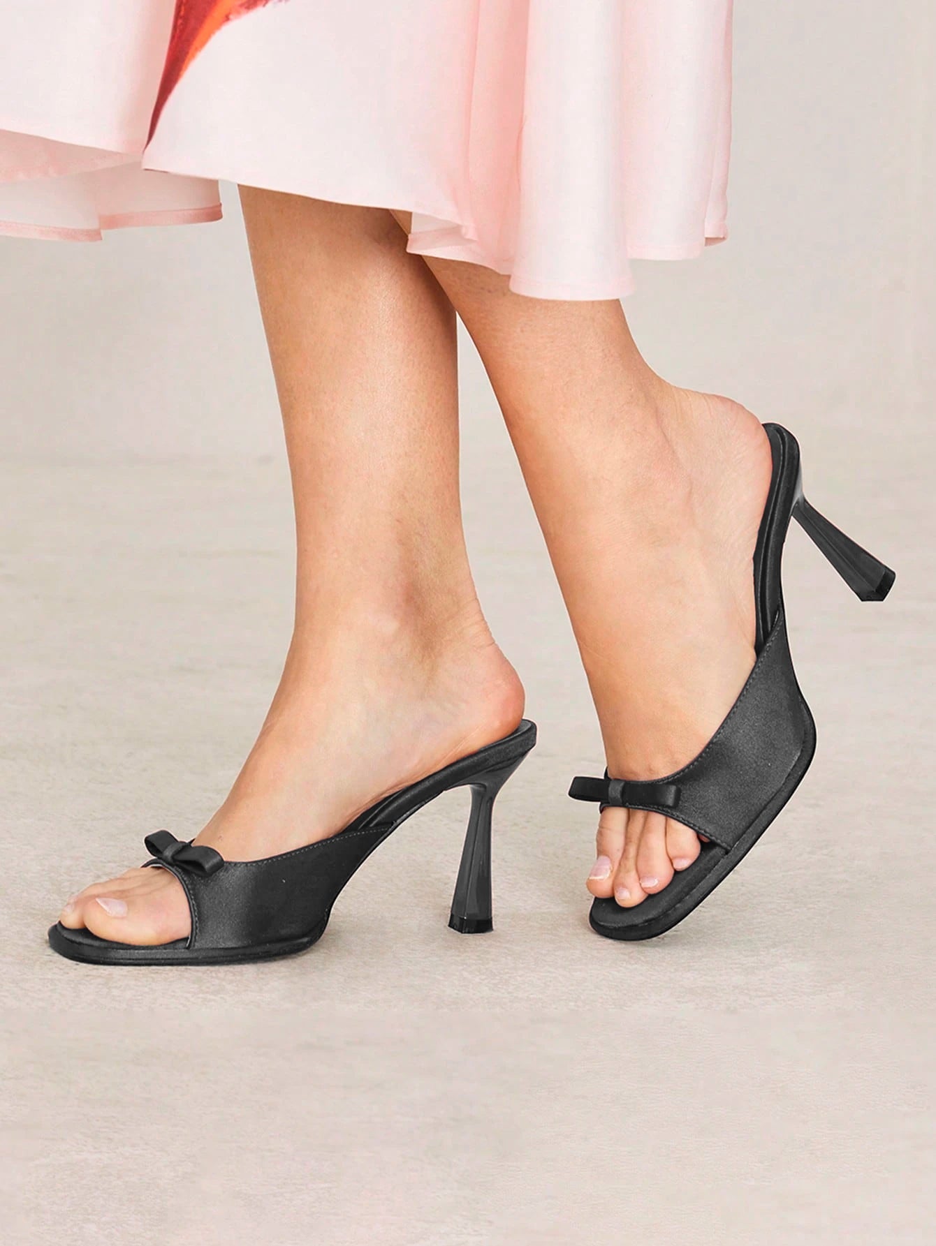 JM Looks heeled mules featuring a small bow detail on the vamp and a sculpted heel
Black