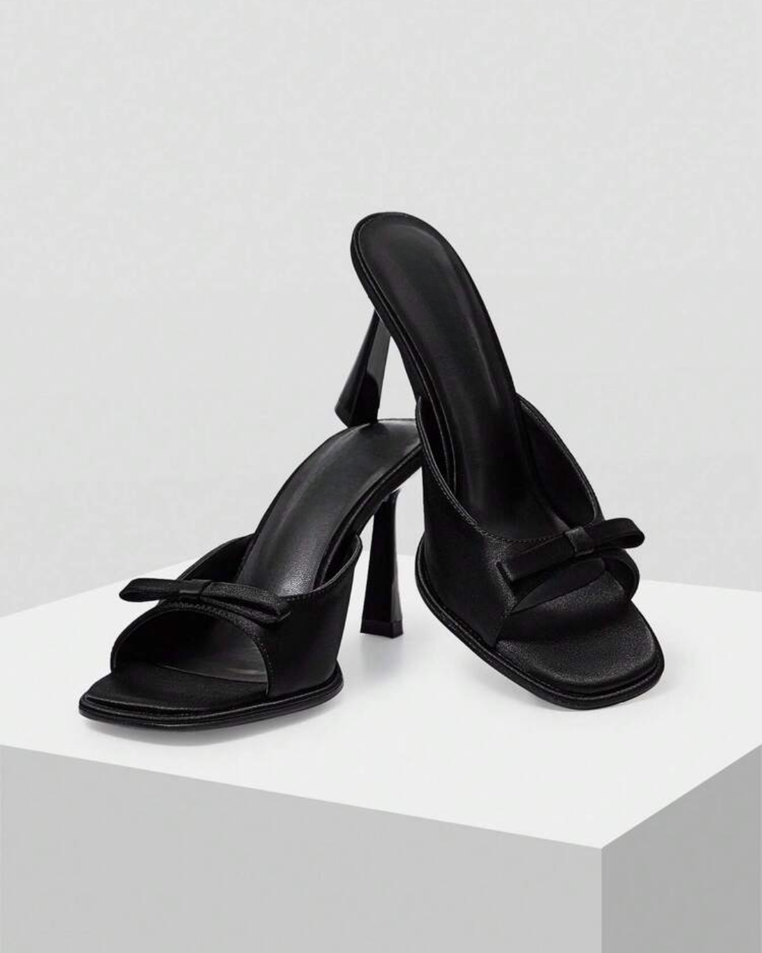 JM Looks heeled mules featuring a small bow detail on the vamp and a sculpted heel
Black