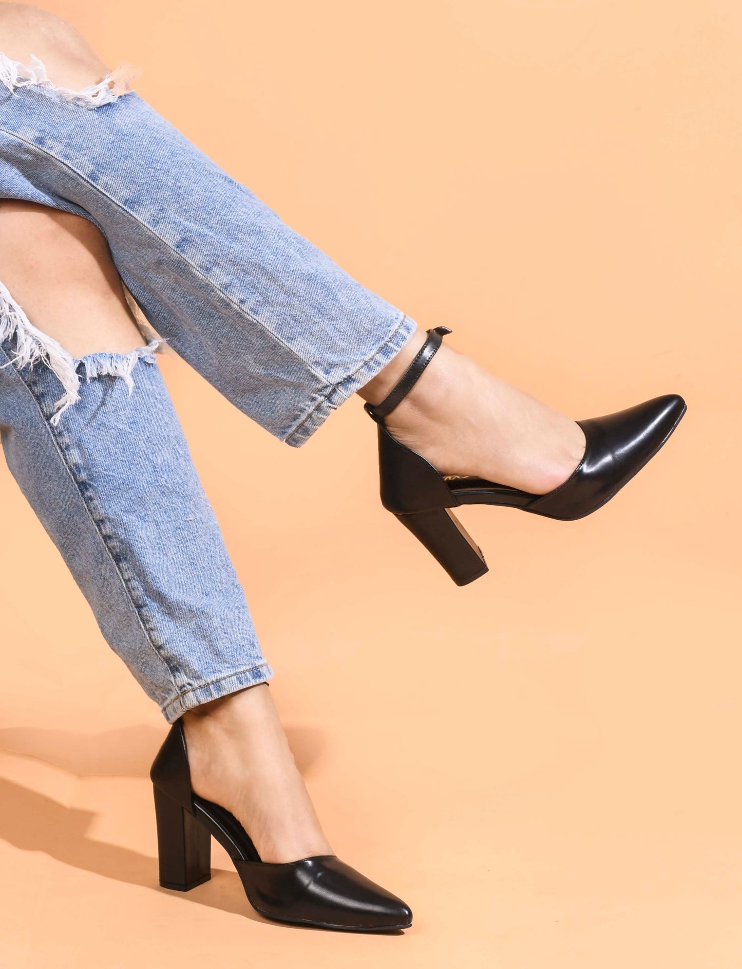 pointed toe block heel pumps with an ankle strap
Black