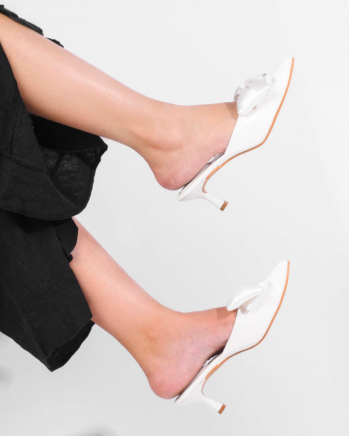 pointed toe heels featuring a large bow detail on the front
White