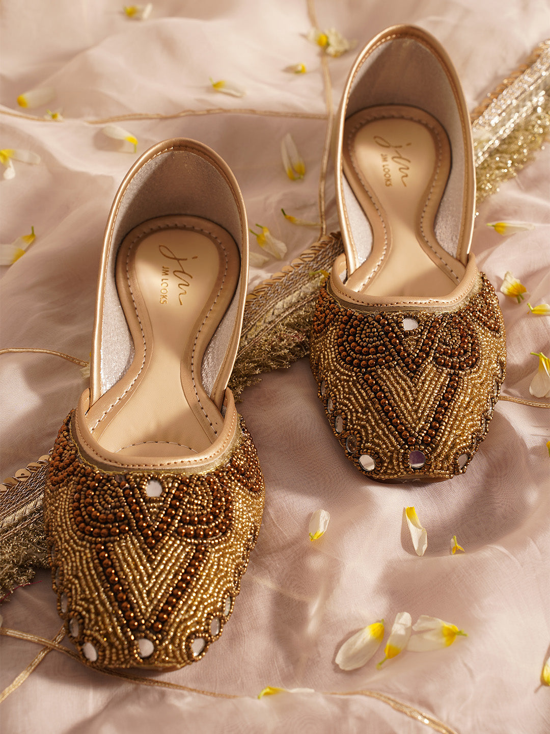 traditional juttis heavily embellished with pearls and beads on the upper
White