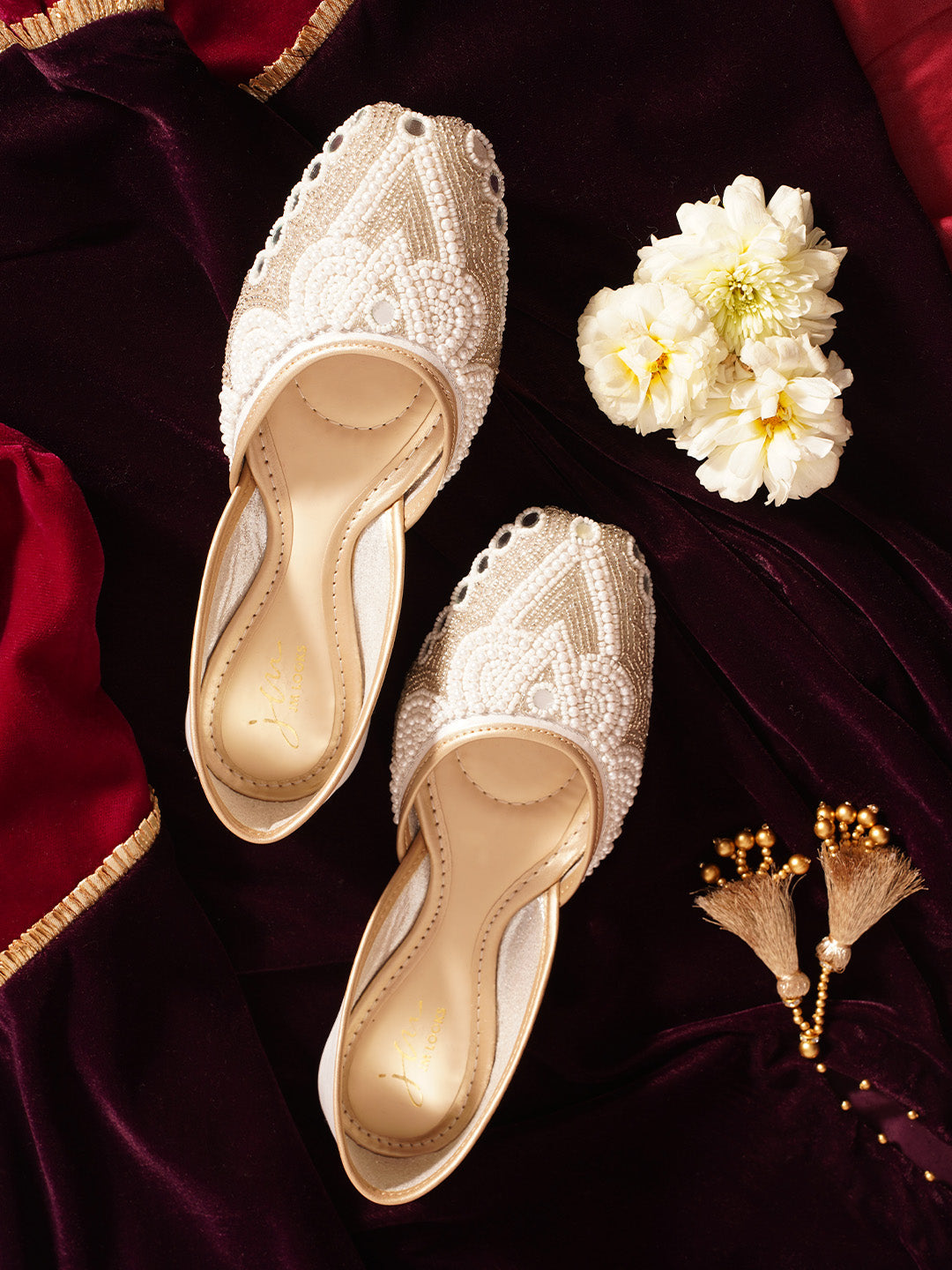 traditional juttis heavily embellished with pearls and beads on the upper
Green