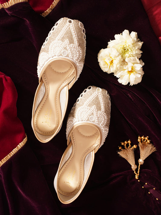 traditional juttis heavily embellished with pearls and beads on the upper
 Green