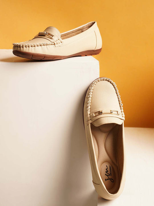 casual loafers with a metal bit embellishment on the vamp and a textured sole
 Cream