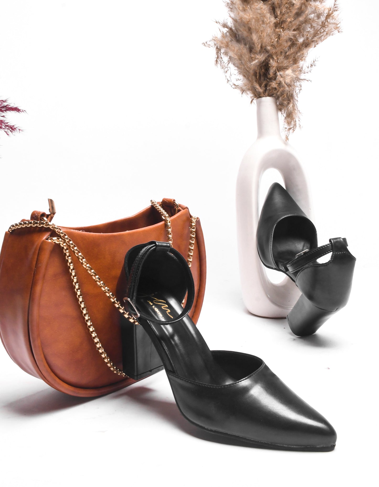 pointed toe block heel pumps with an ankle strap
Black