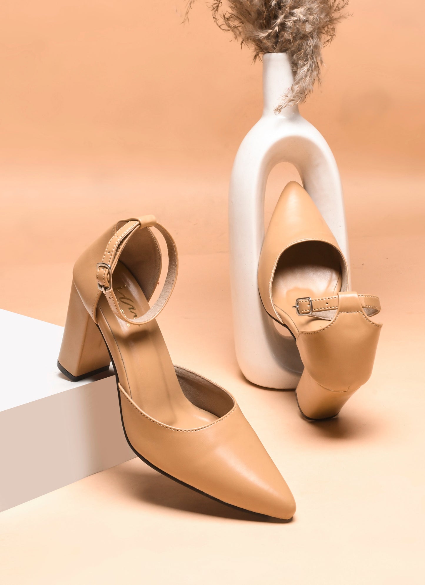 pointed toe block heel pumps with an ankle strap
Beige
