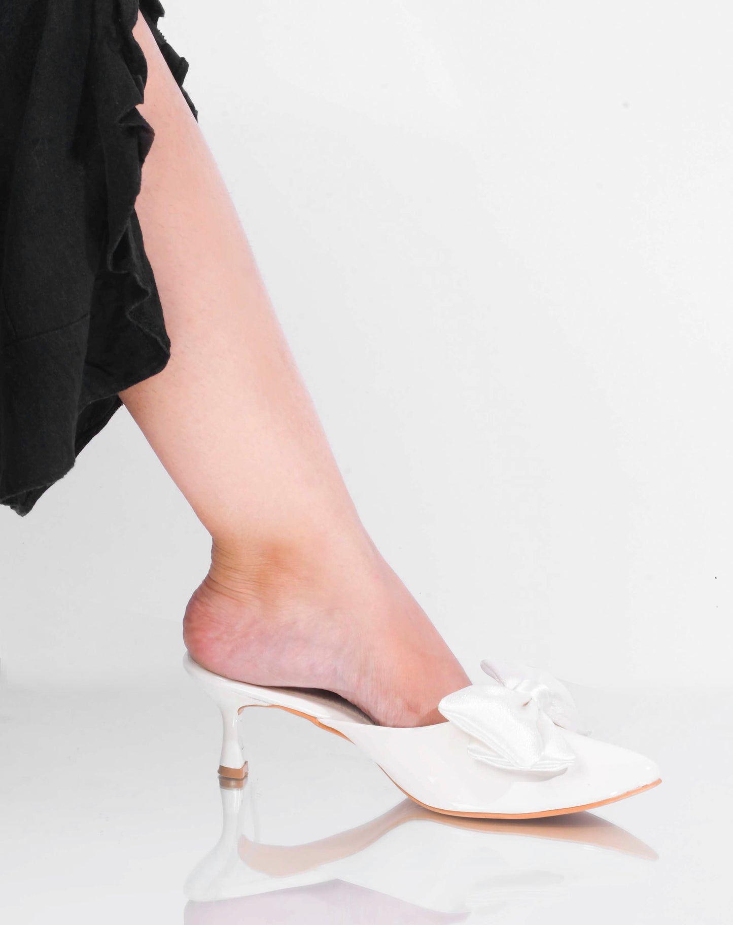pointed toe heels featuring a large bow detail on the front
White