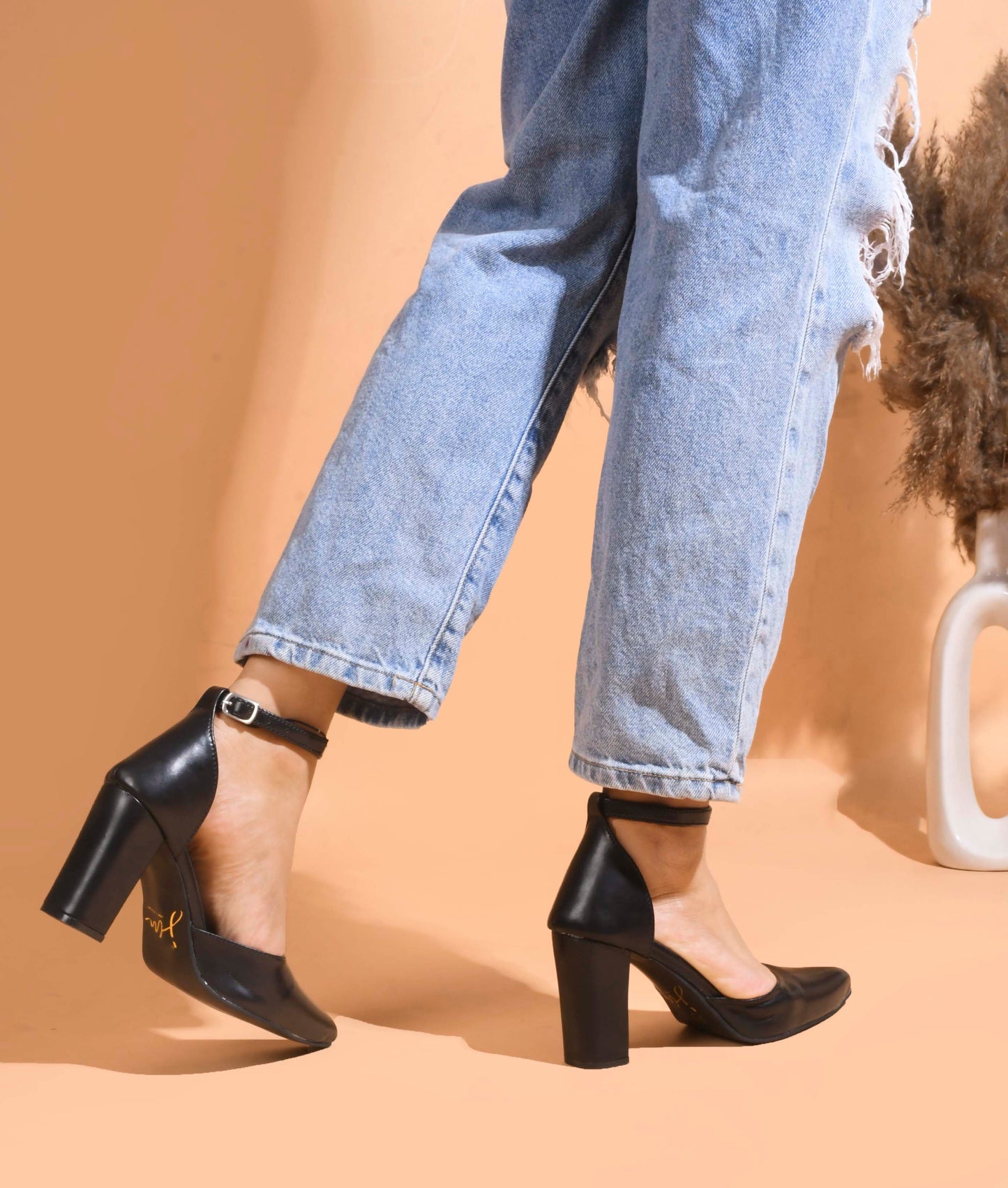 pointed toe block heel pumps with an ankle strap
Black