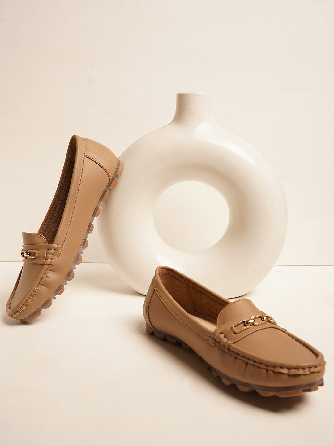 casual loafers with a metal bit embellishment on the vamp and a textured sole
Beige