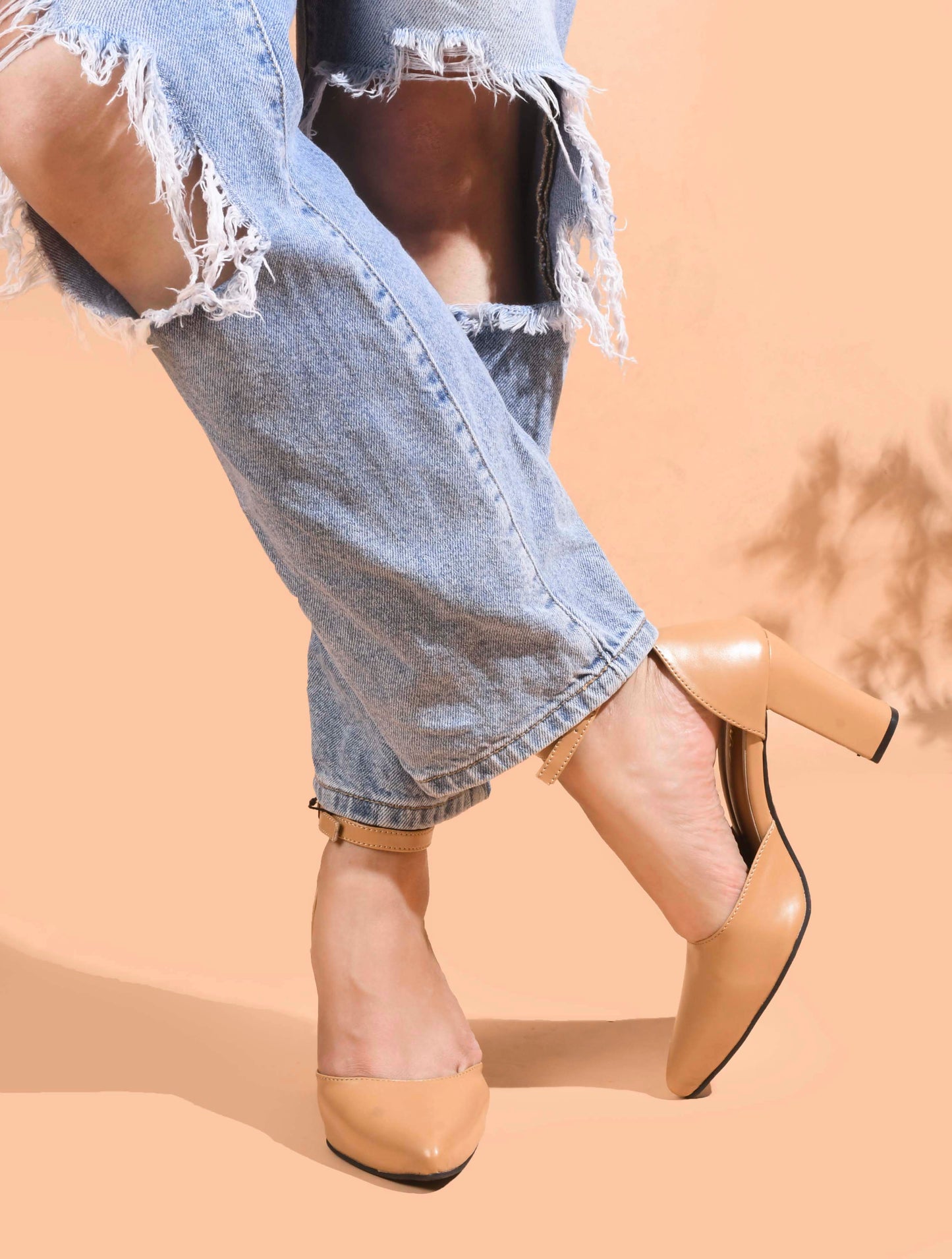 pointed toe block heel pumps with an ankle strap
Beige