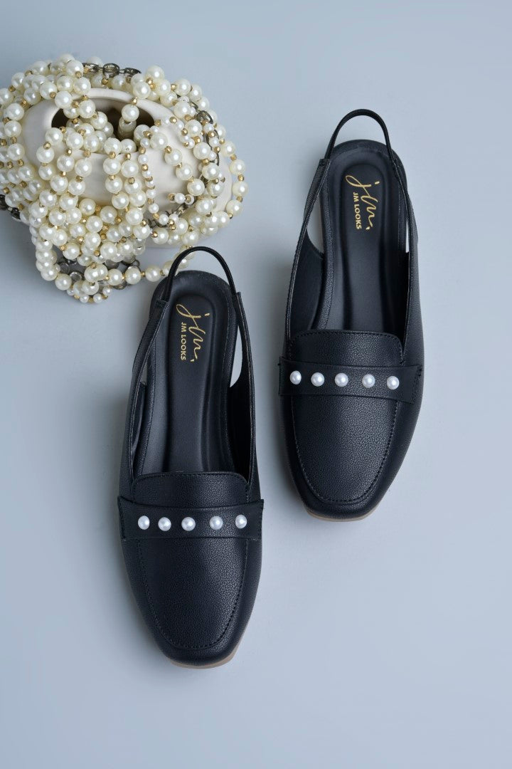 Jm Looks beige slingback loafers adorned with small pearls on the vamp, with a string of pearls in the background
Black