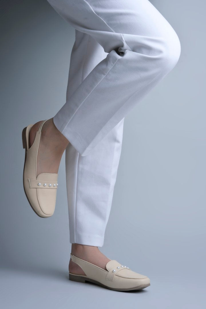 Jm Looks beige slingback loafers adorned with small pearls on the vamp, with a string of pearls in the background
Cream