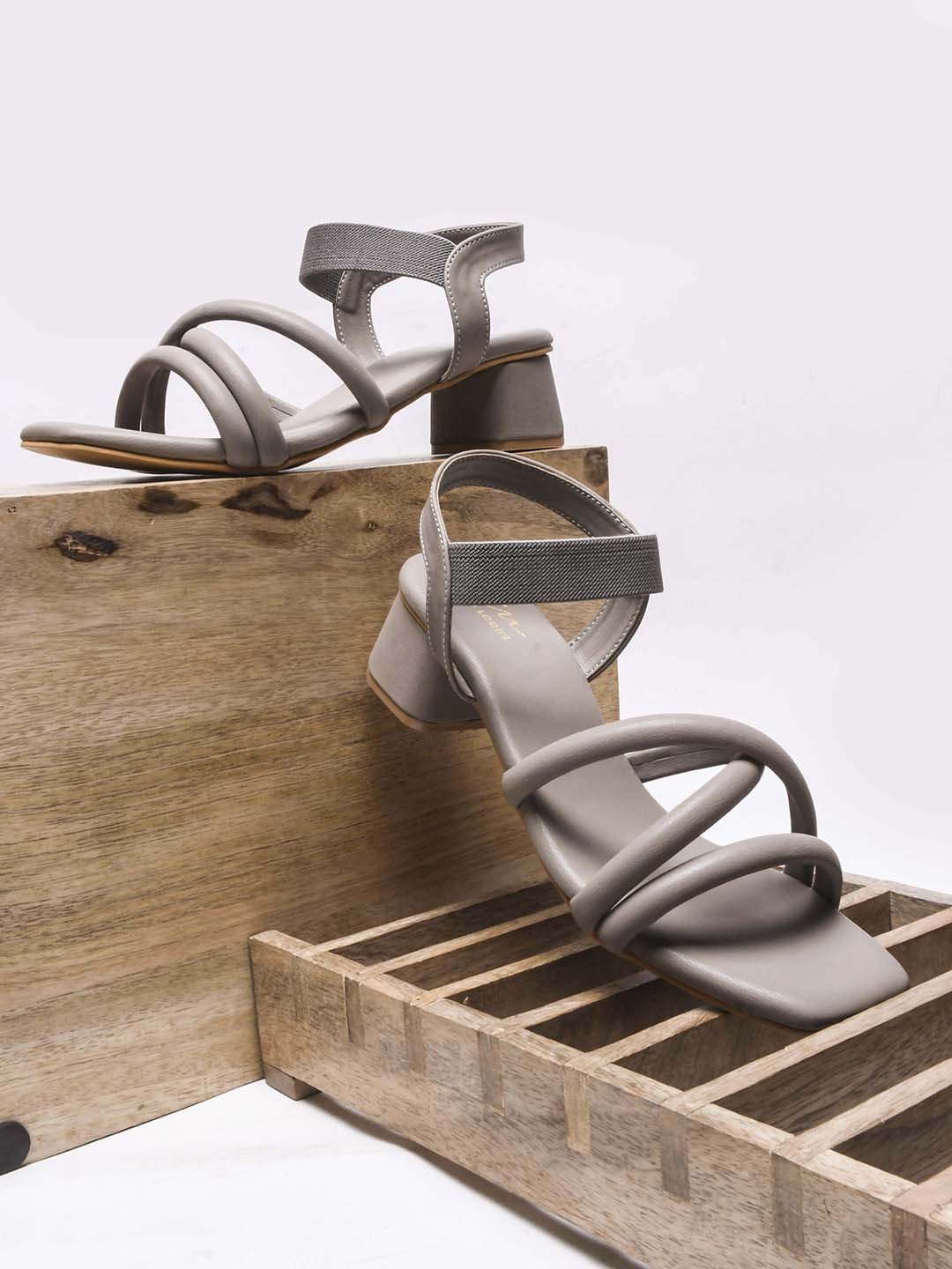 block heel sandals featuring padded, intertwined straps and an adjustable ankle strap
Beige