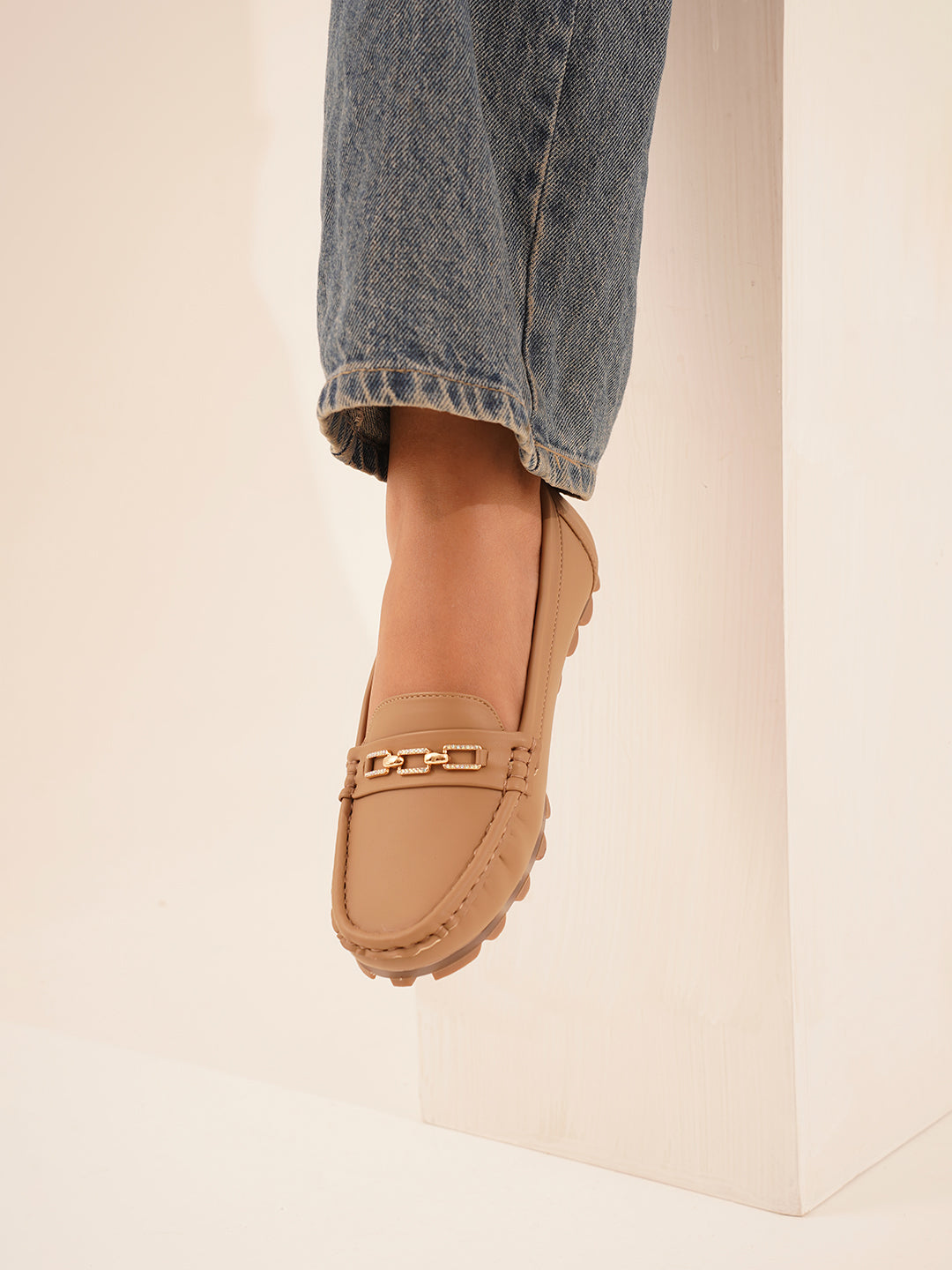casual loafers with a metal bit embellishment on the vamp and a textured sole
Beige