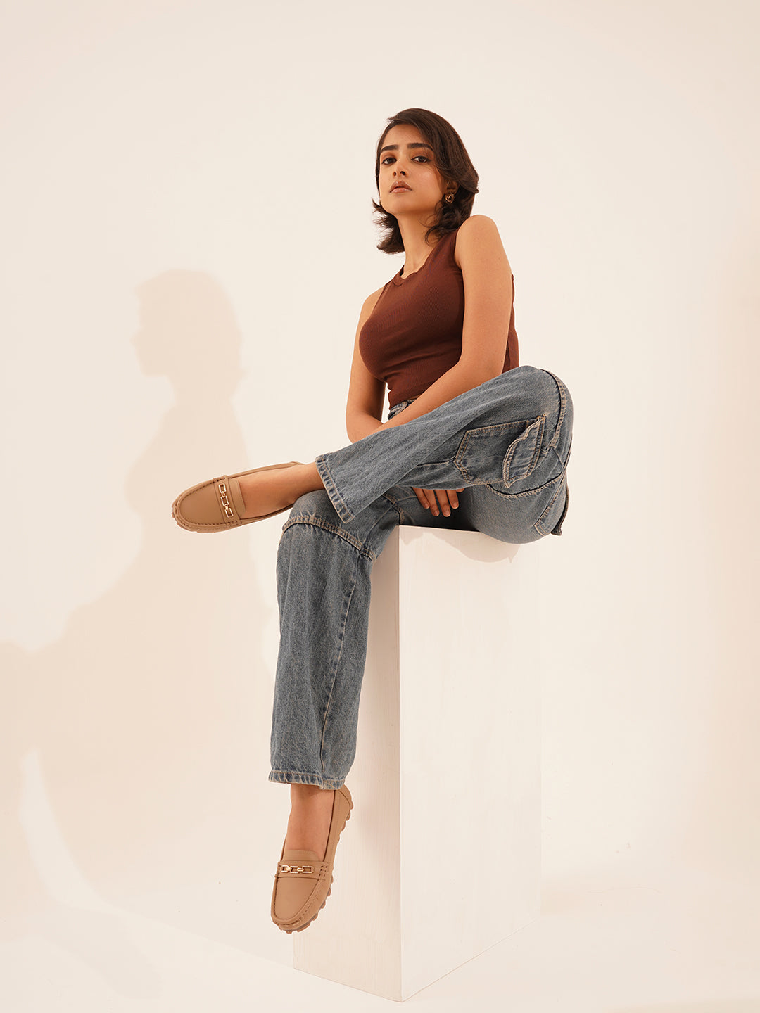 casual loafers with a metal bit embellishment on the vamp and a textured sole
Beige