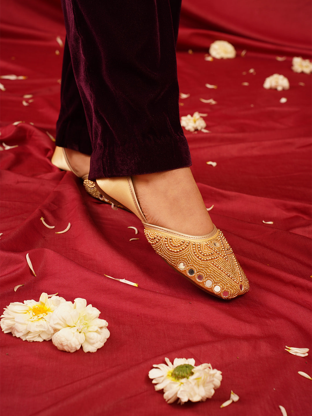 traditional juttis heavily embellished with pearls and beads on the upper
Golden