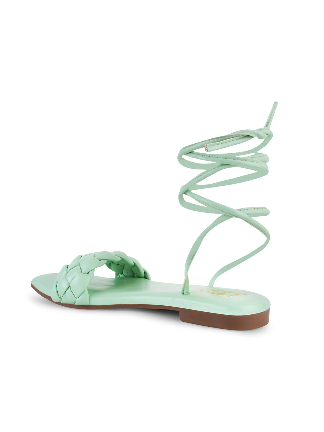 flat sandals featuring a braided front strap and long lace-up ankle straps
Green
