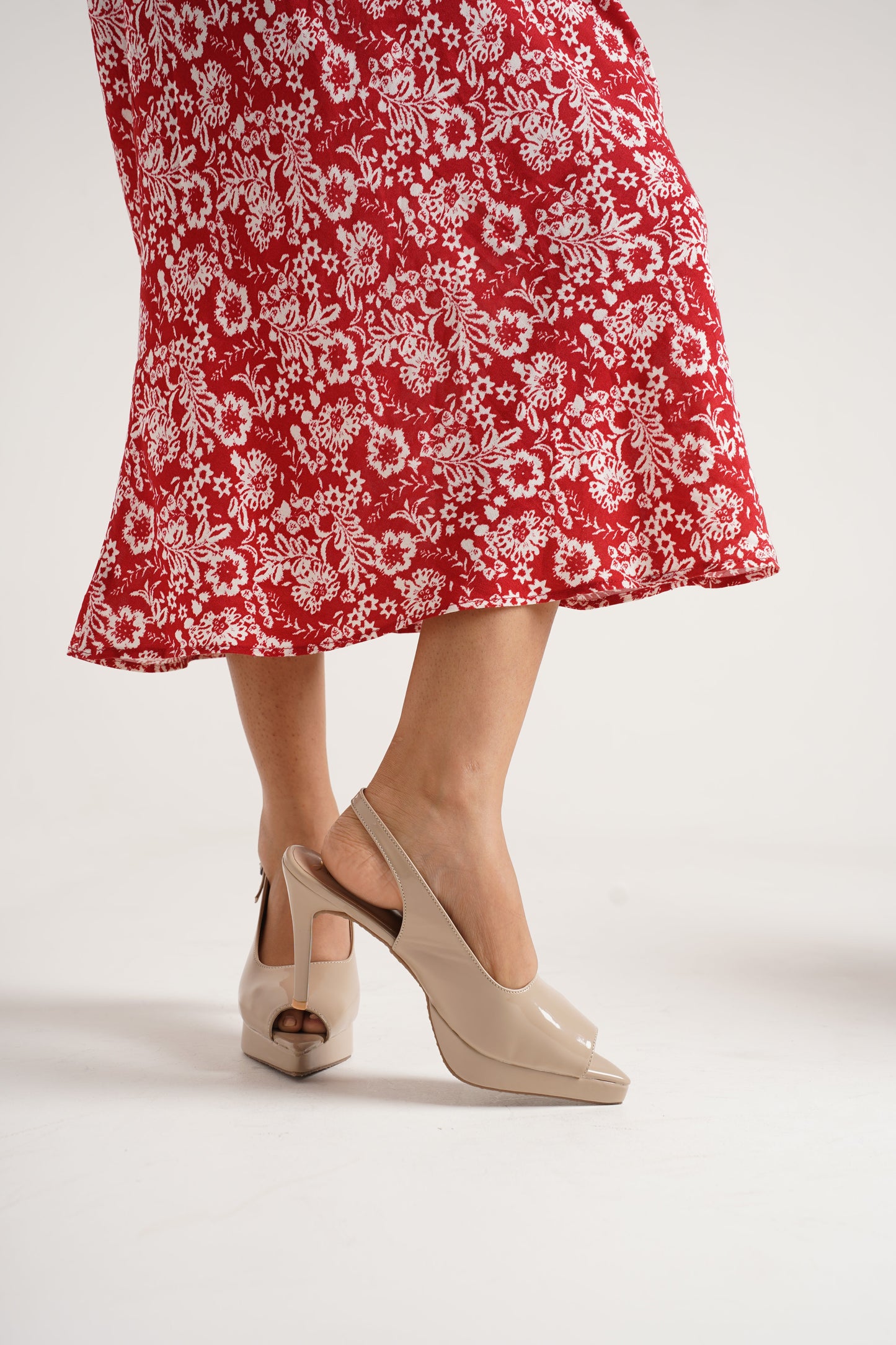 Jm Looks black patent slingback heels with a high stiletto heel and platform
Cream
