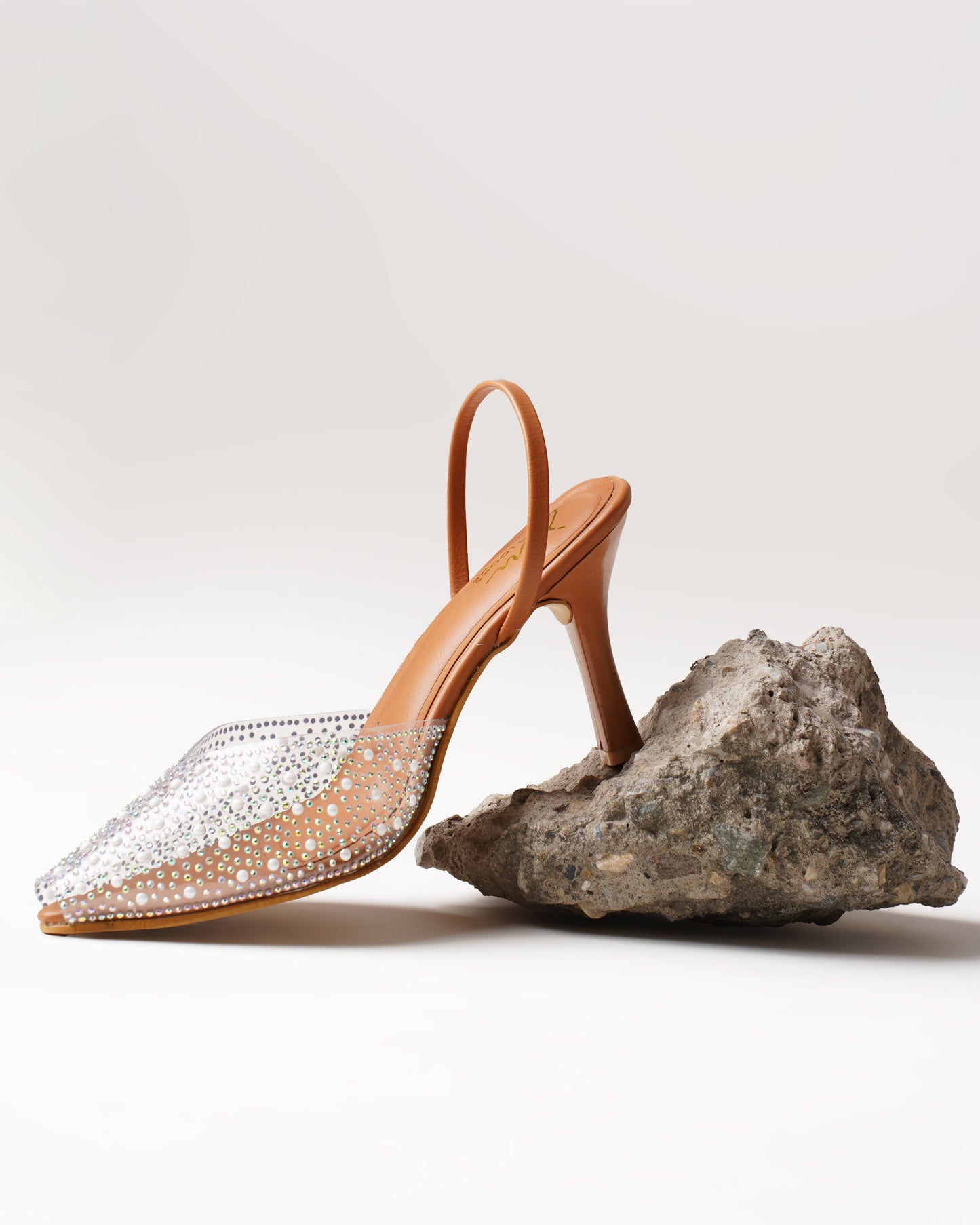 pointed toe slingback heels adorned with sparkling embellishments
Tan