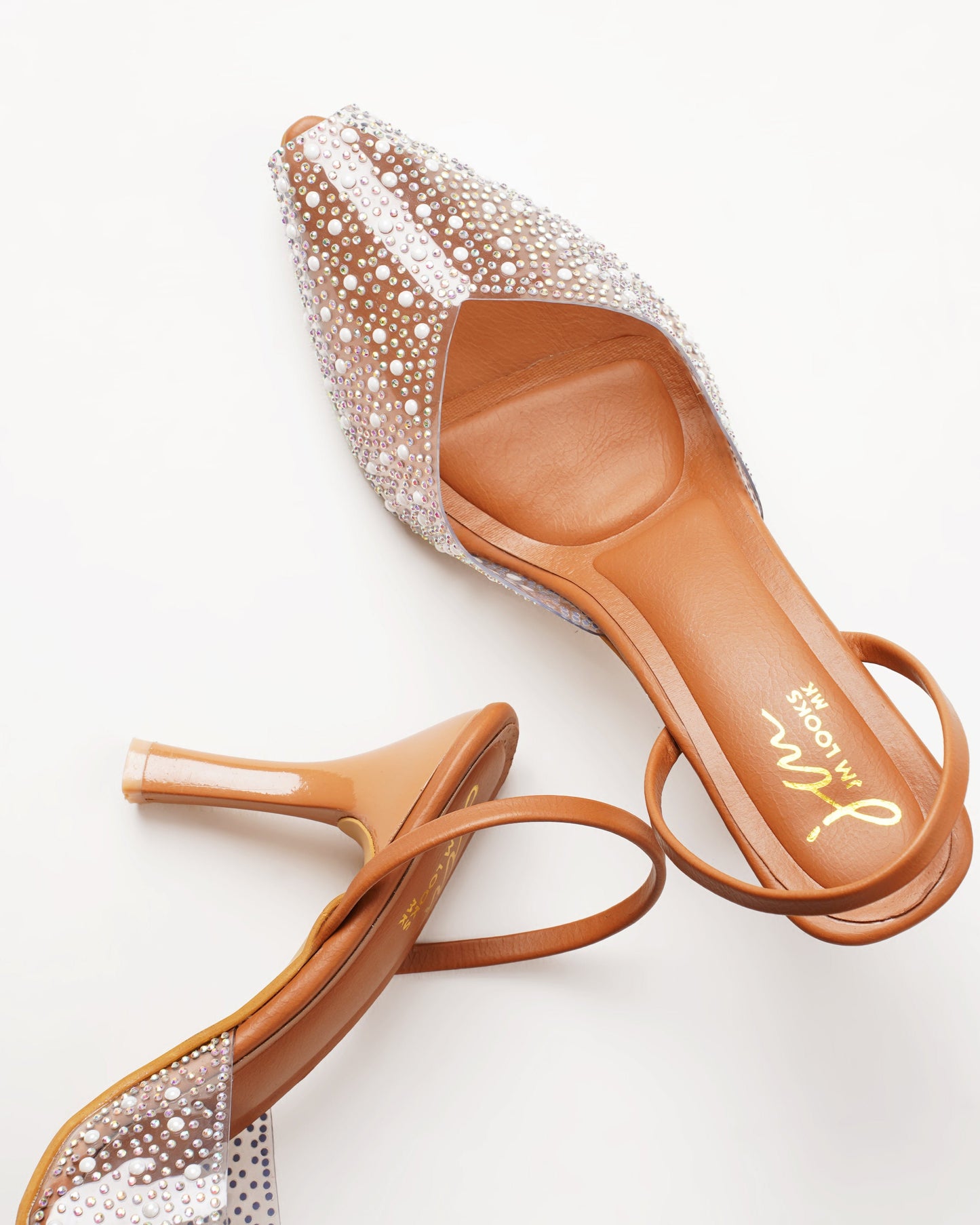 pointed toe slingback heels adorned with sparkling embellishments
Tan