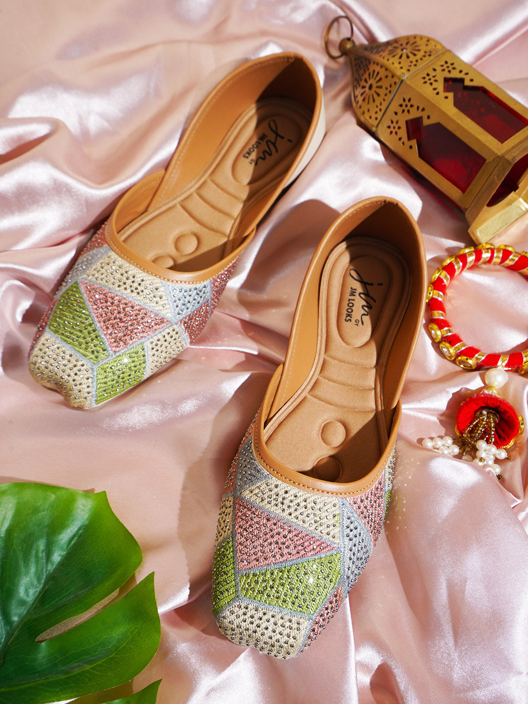 embellished juttis featuring a vibrant geometric pattern with sparkling details
Cream