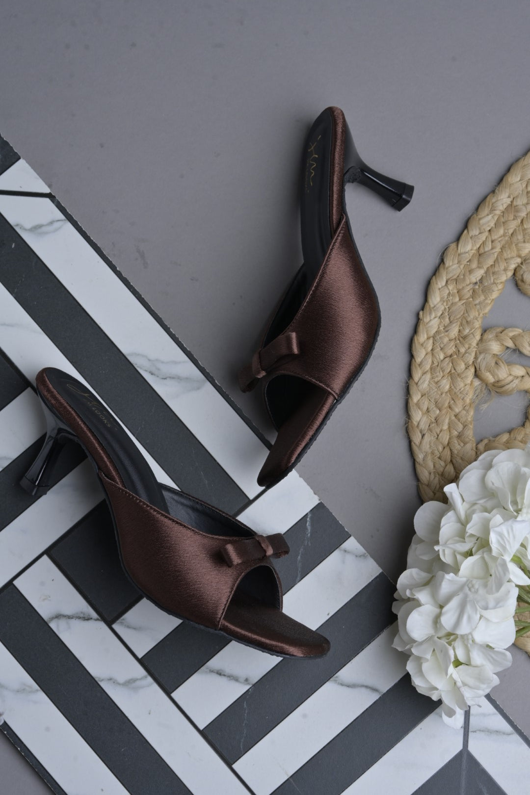 JM Looks heeled mules featuring a small bow detail on the vamp and a sculpted heel
Copper