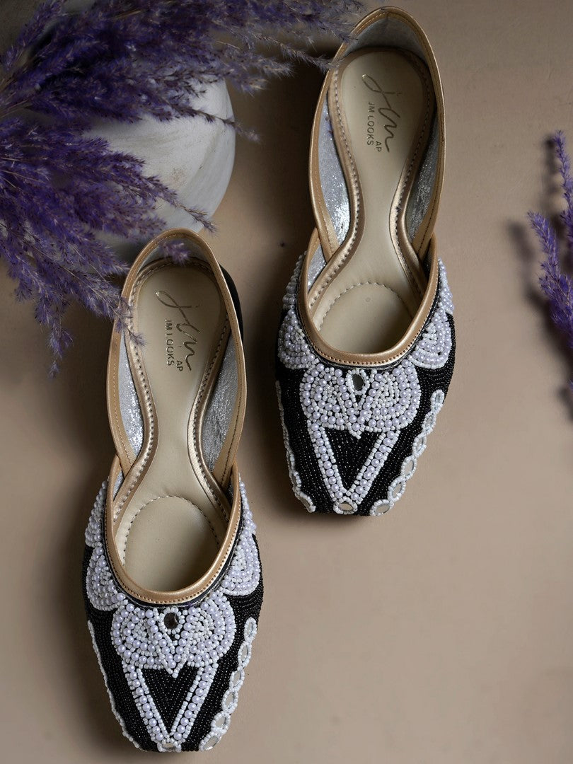 traditional juttis heavily embellished with pearls and beads on the upper
Black