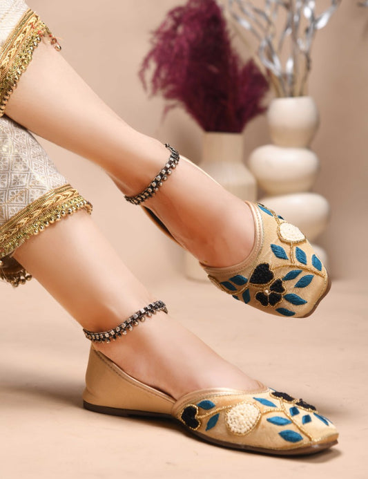 exquisitely embroidered juttis featuring floral and leaf patterns
 Golden