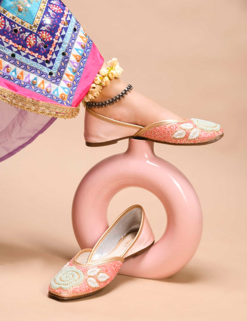 exquisitely beaded juttis featuring a floral design with intricate patterns
Peach