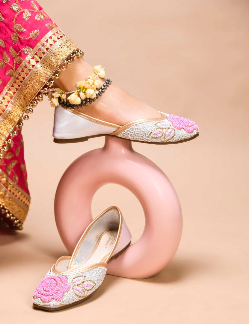 exquisitely beaded juttis featuring a floral design with intricate patterns
White