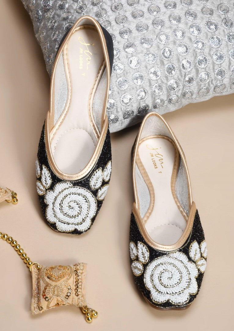 exquisitely beaded juttis featuring a floral design with intricate patterns
Black
