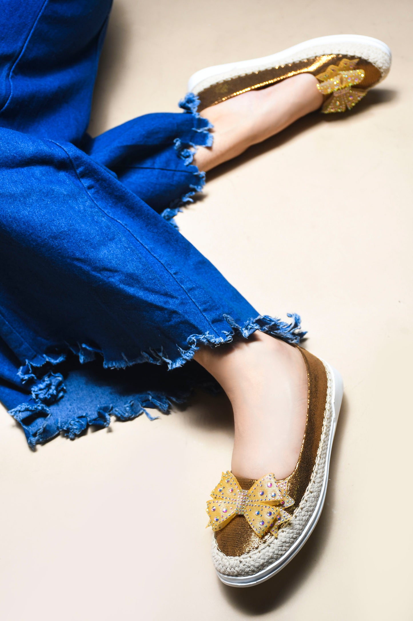 JM Looks espadrille loafers featuring a shimmering toe, a rhinestone-embellished bow, and a woven sole
Copper