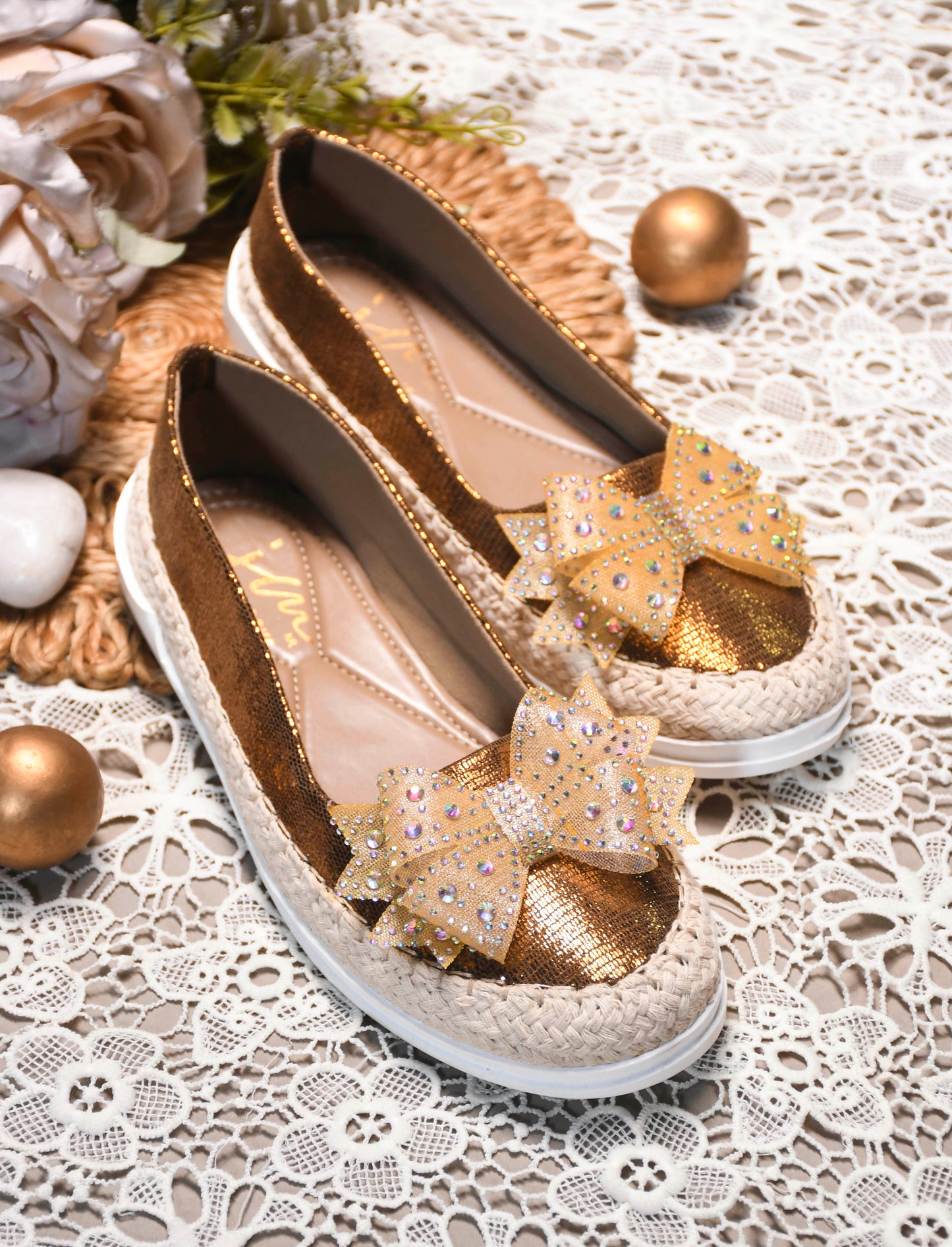 JM Looks espadrille loafers featuring a shimmering toe, a rhinestone-embellished bow, and a woven sole
Copper