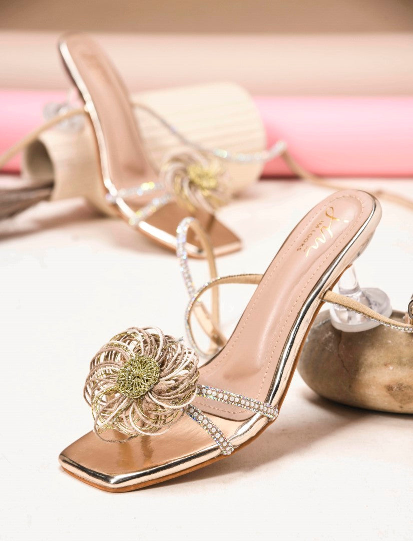 Jm Looks stiletto heels with a floral embellishment on the front and shimmering ankle-wrap straps
Golden