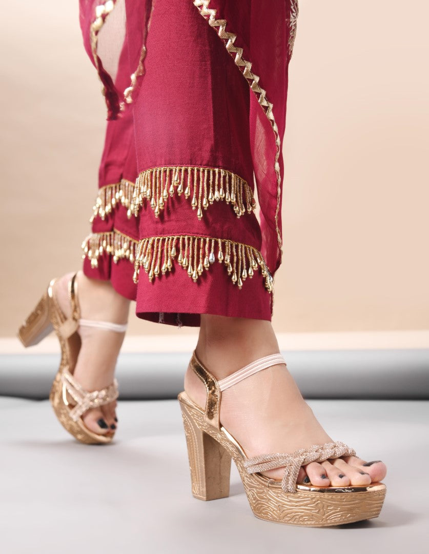Jm Looks platform heels with braided straps and an ankle strap, paired with traditional attire
Sultan