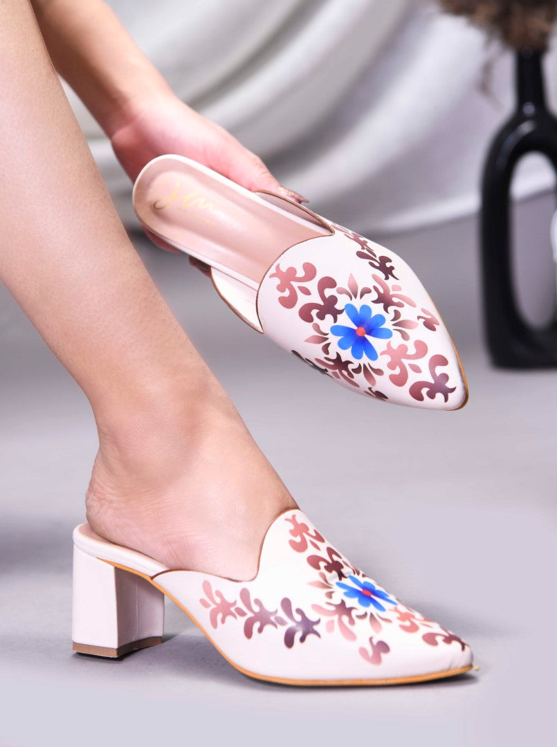 A women's mule shoe featuring a charming floral design and a block heel
Cream