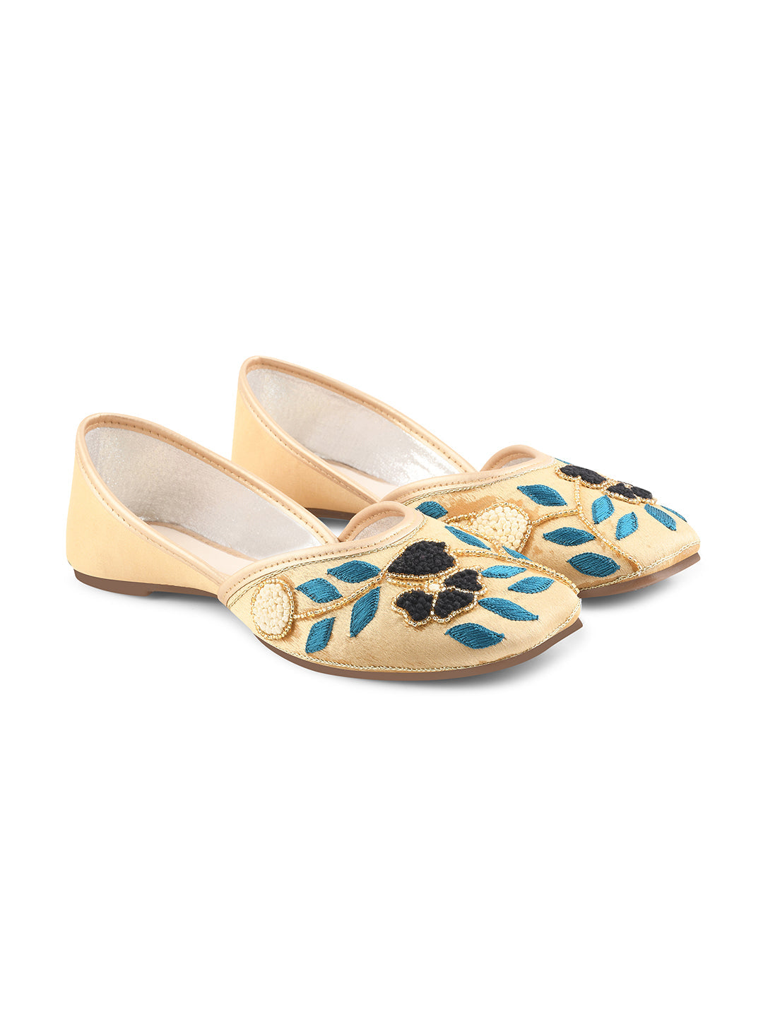exquisitely embroidered juttis featuring floral and leaf patterns
Golden