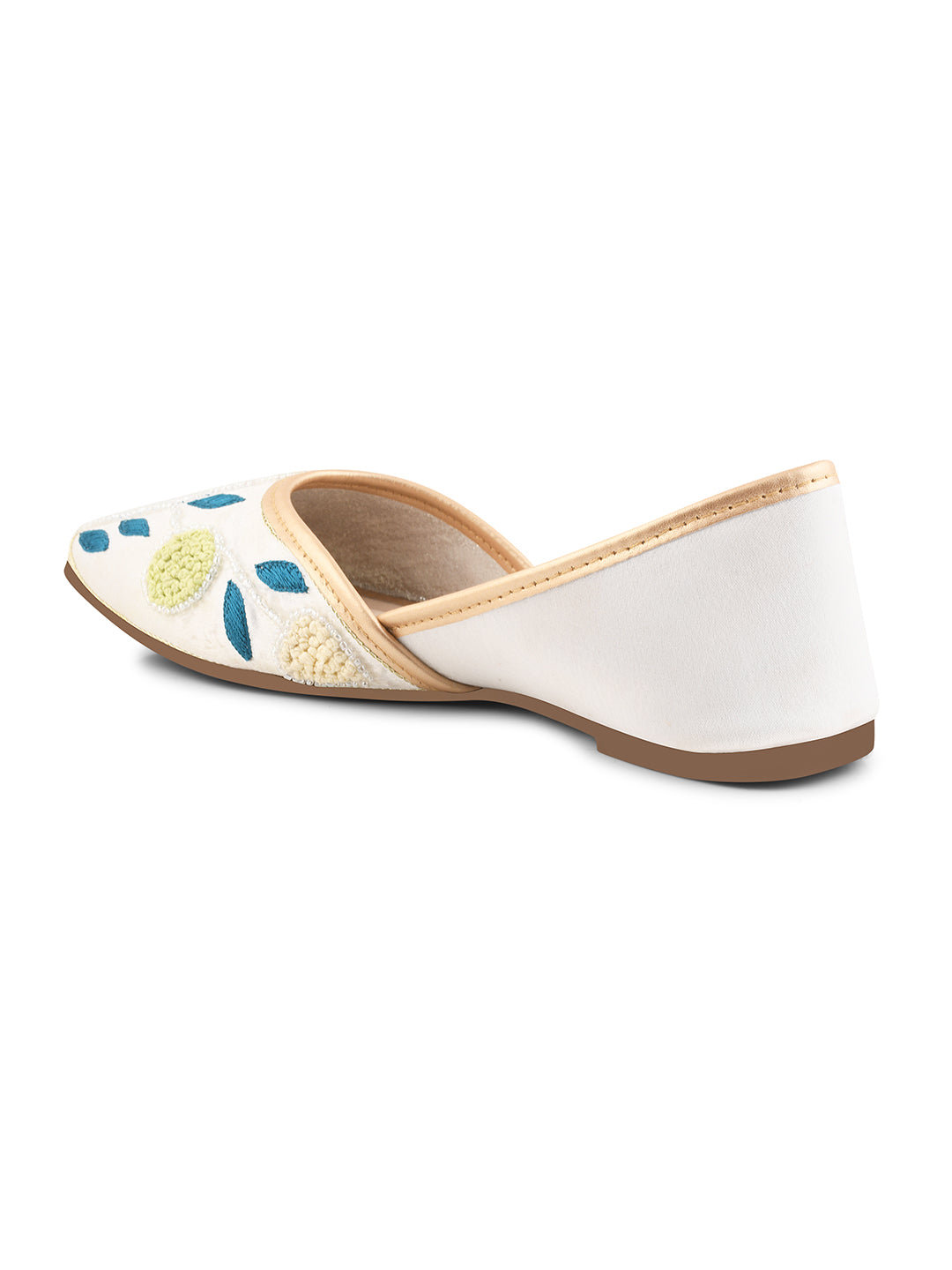 exquisitely embroidered juttis featuring floral and leaf patterns
White