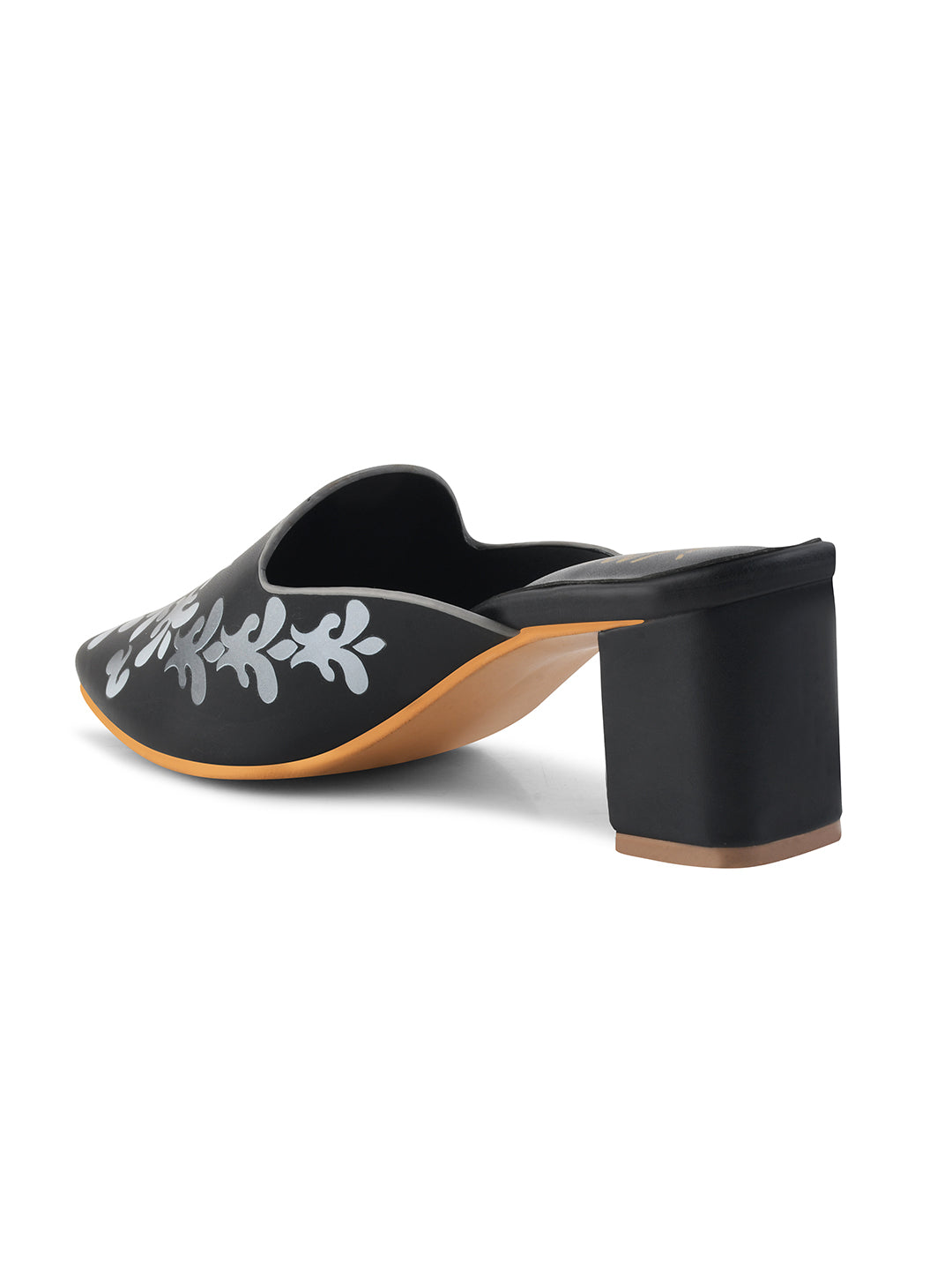A women's mule shoe featuring a charming floral design and a block heel
Black
