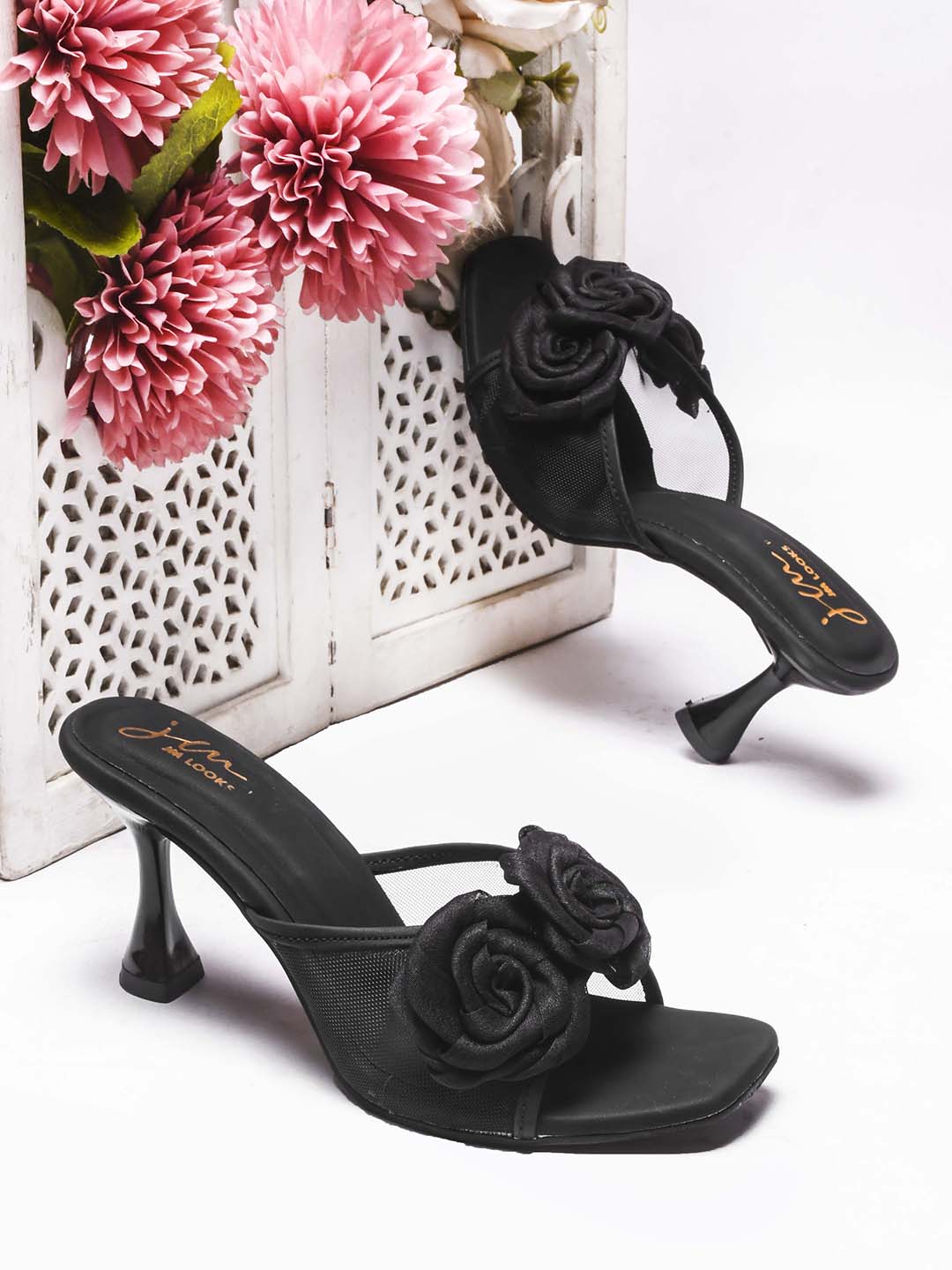 JM Looks heeled mules featuring two prominent floral appliques on the vamp strap and a flared heel
Black