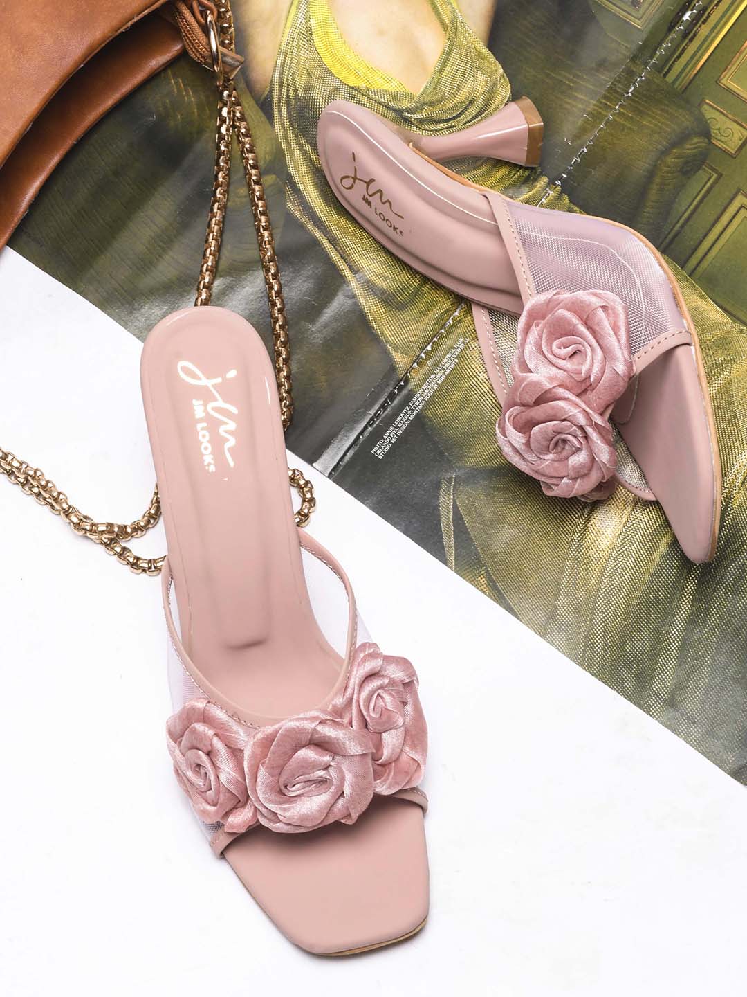 JM Looks heeled mules featuring two prominent floral appliques on the vamp strap and a flared heel
Peach