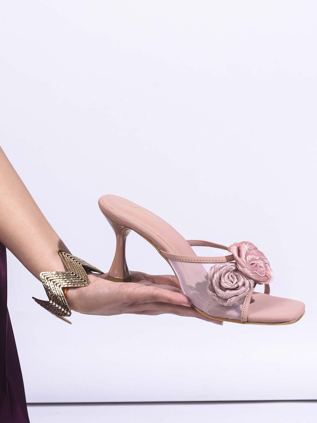 JM Looks heeled mules featuring two prominent floral appliques on the vamp strap and a flared heel
Peach