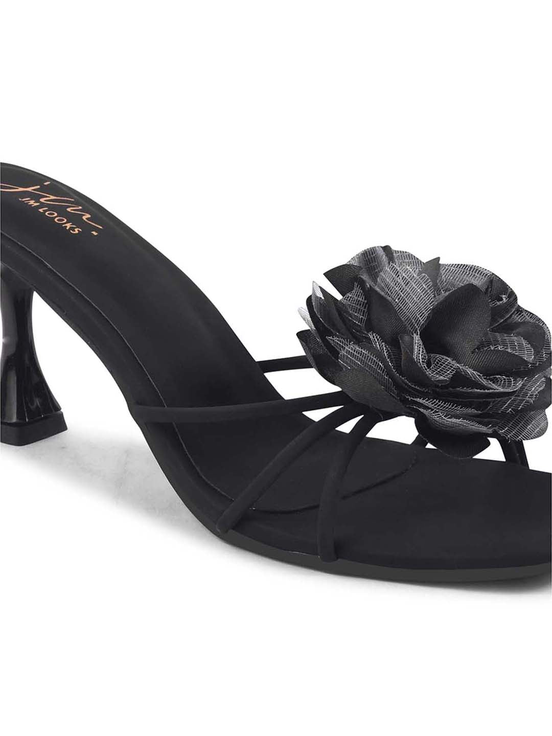 women's heeled mules featuring a large floral embellishment on the strap
Black