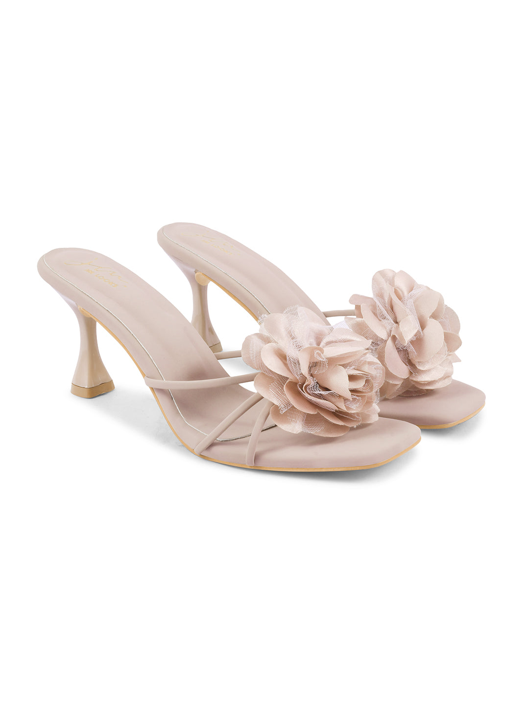 women's heeled mules featuring a large floral embellishment on the strap
Purple
