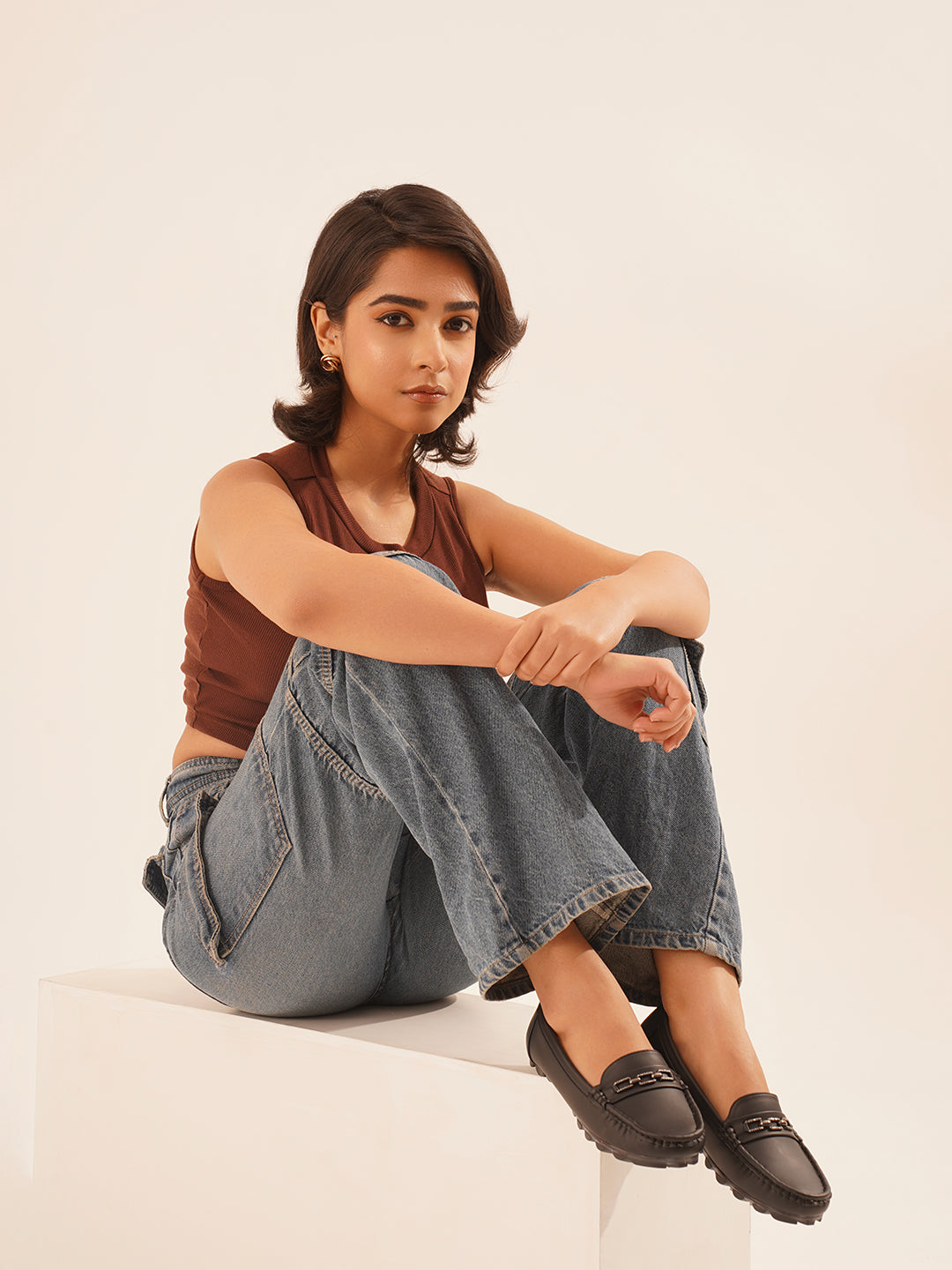 casual loafers with a metal bit embellishment on the vamp and a textured sole
Black
