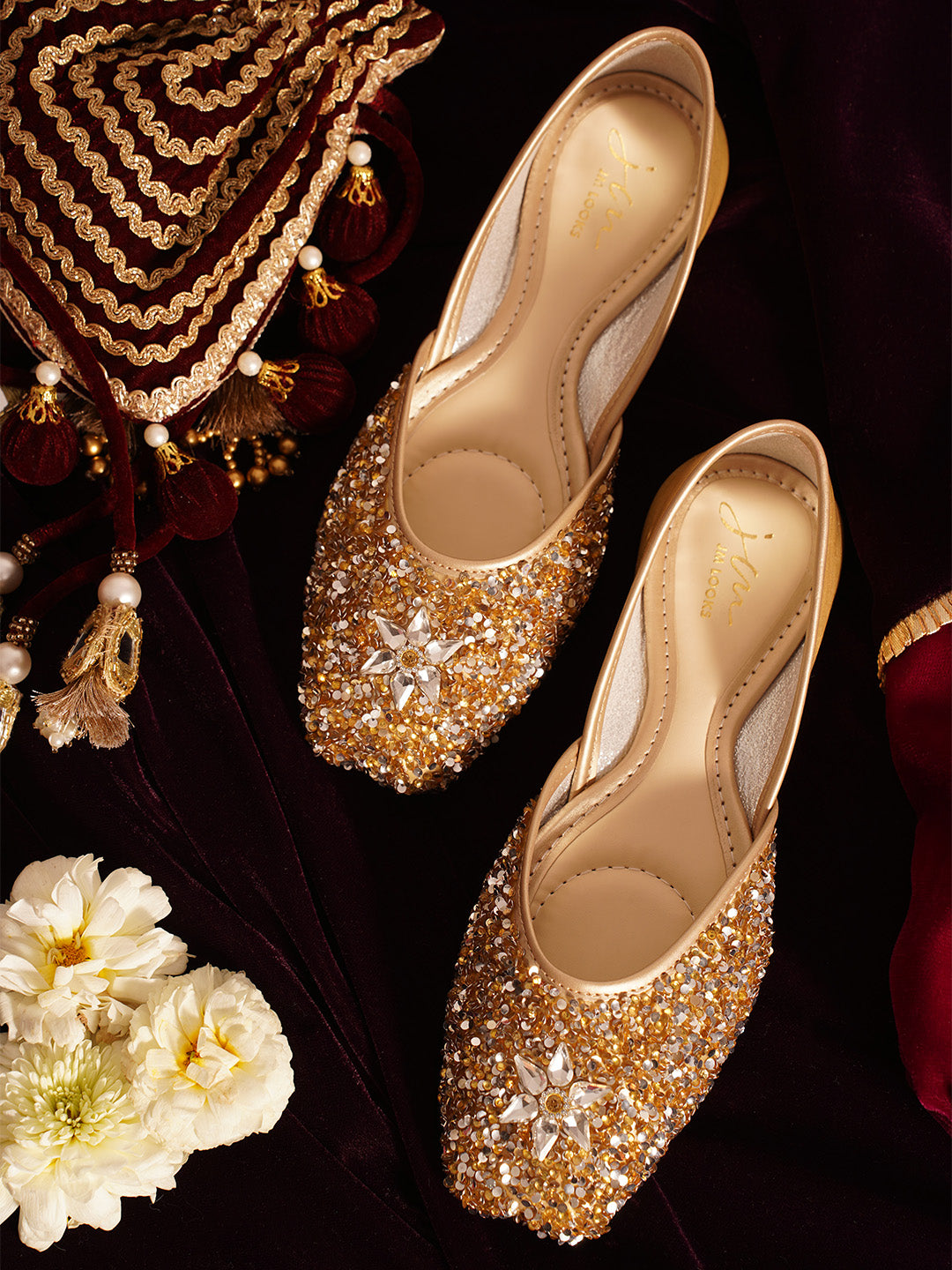 traditional juttis heavily embellished with sequins and a large floral motif at the toe
Golden